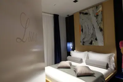 a bedroom with a bed with white pillows at Navona Rooms in Rome