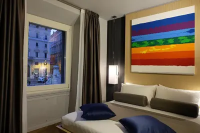a bedroom with a bed and a window with a painting at Navona Rooms in Rome