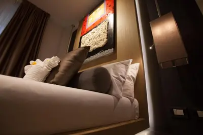 a hotel room with a couch with pillows and a lamp at Navona Rooms in Rome