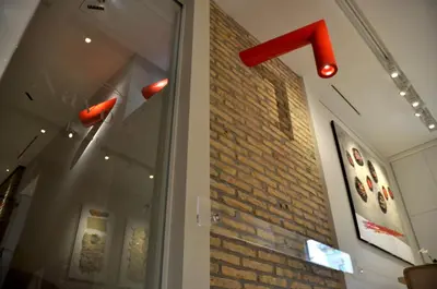 a brick wall next to a door with a red light at Navona Rooms in Rome