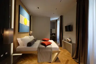 a hotel room with a bed with red pillows on it at Navona Rooms in Rome