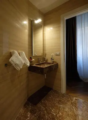 a bathroom with a sink and a mirror at Navona Rooms in Rome