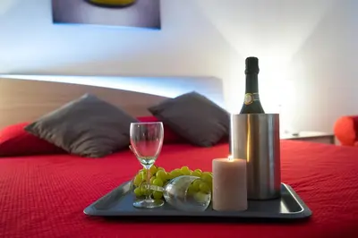 a tray with a bottle of wine and a glass at Vatican Art Place in Rome