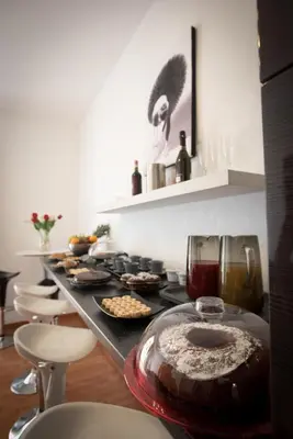 a long counter with a table with food on it at Vatican Art Place in Rome