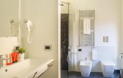 a white bathroom with a sink and a toilet at Navona Living Rome in Rome