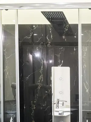 a black and white kitchen with a sink and a mirror at Navona Living Rome in Rome