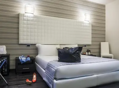 a bedroom with a bed with a black bag on it at Navona Living Rome in Rome