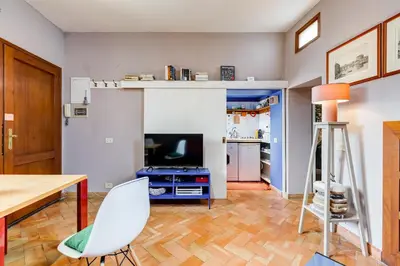a living room with a dining room table and a kitchen at Campo Marzio Boutique Apt 300 mt dal Pantheon in Rome