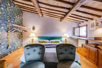 a bedroom with a bed and two chairs at Campo Marzio Boutique Apt 300 mt dal Pantheon in Rome