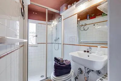 a bathroom with a sink and a shower at Campo Marzio Boutique Apt 300 mt dal Pantheon in Rome