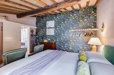a bedroom with a bed and two chairs at Campo Marzio Boutique Apt 300 mt dal Pantheon in Rome