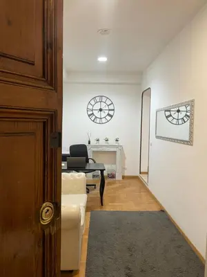 a living room with a couch and a table and a clock at Ripetta 35 in Rome