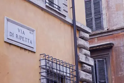 a street sign on the side of a building at Ripetta 35 in Rome