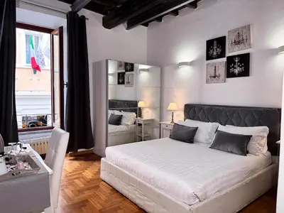a bedroom with a white bed and a window at Ripetta 35 in Rome