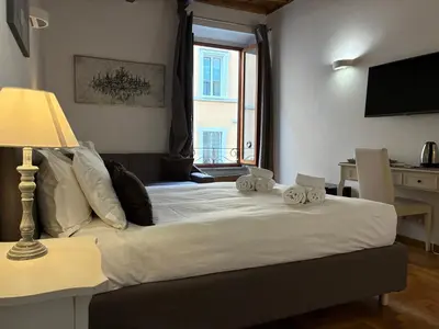 a bedroom with a large white bed with a window at Ripetta 35 in Rome