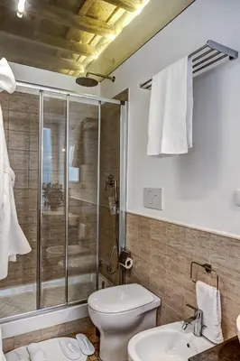 a bathroom with a shower and a toilet and a sink at Good Life Monti in Rome