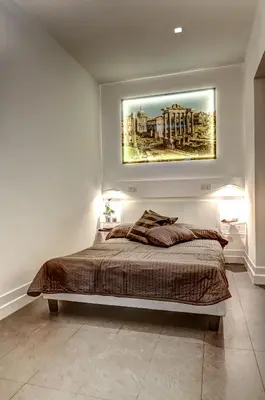 a bedroom with a bed with a painting on the wall at Good Life Monti in Rome