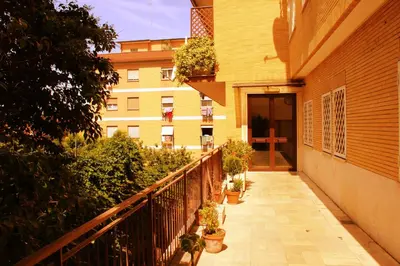 a balcony of a building with potted plants on it at Tempio del Sole in Rome