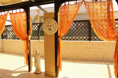 a room with orange curtains and a sign on a pole at Tempio del Sole in Rome