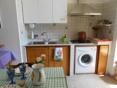 a kitchen with a sink and a washing machine at Da Anita in Rome