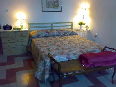 a bedroom with a bed with a dresser and two lamps at Da Anita in Rome