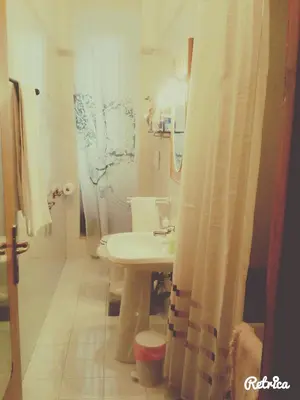 a bathroom with a sink and a shower curtain at Da Anita in Rome