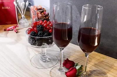 two glasses of wine and a bowl of fruit on a table at Sun Suite Luxury Pantheon in Rome