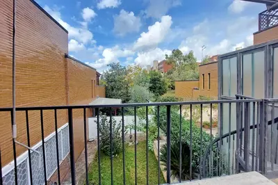 a balcony with a fence next to a building at Il Villino di Adelchi by DomusDimore in Rome