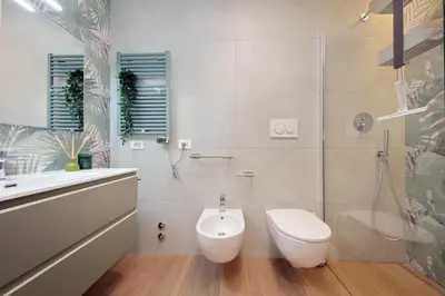 a white bathroom with a toilet and a sink at Il Villino di Adelchi by DomusDimore in Rome