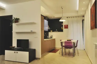 a kitchen and dining room with a table and chairs at Kings Of Rome Apartments in Rome