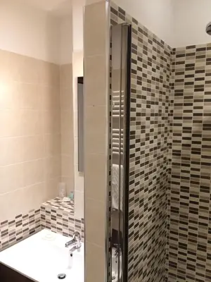 a bathroom with a sink and a shower at Kings Of Rome Apartments in Rome