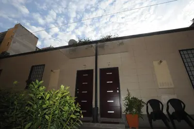 a building with two black doors and plants at Kings Of Rome Apartments in Rome