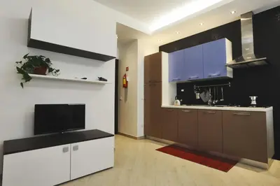 a kitchen with a television and a large kitchen at Kings Of Rome Apartments in Rome