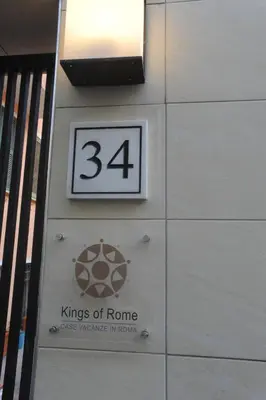 a sign for the kings of rome on the side of a building at Kings Of Rome Apartments in Rome