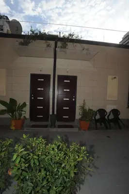 a building with two brown doors and some plants at Kings Of Rome Apartments in Rome