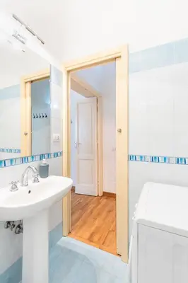 a bathroom with a sink and a mirror and a toilet at Casa Elena - ItalyHolidayHouse in Rome