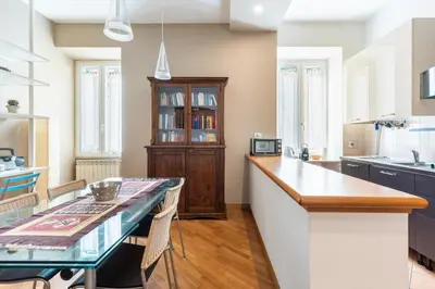 a kitchen with a table and a counter top at Casa Elena - ItalyHolidayHouse in Rome
