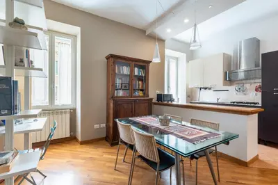 a kitchen and dining room with a table and chairs at Casa Elena - ItalyHolidayHouse in Rome