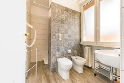 a bathroom with a toilet and a sink at Un Attimo A Roma B&B in Rome