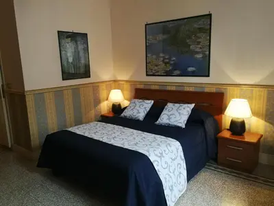 a bedroom with a bed and two lamps on tables at B&B La Bella Giuliana in Rome