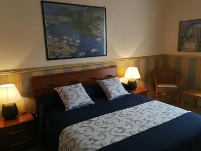 a bedroom with a bed with two lamps and a painting at B&B La Bella Giuliana in Rome