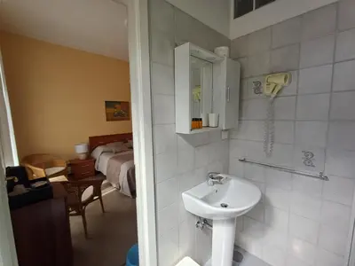 a bathroom with a sink and a phone on the wall at B&B La Bella Giuliana in Rome