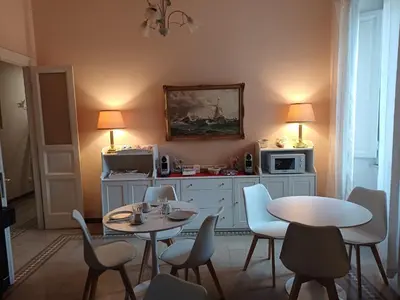 a room with two tables and chairs and a microwave at B&B La Bella Giuliana in Rome