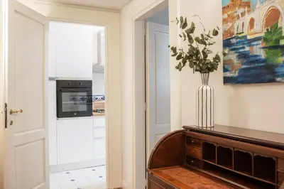 a kitchen with a vase of flowers on a table at Avila Palace Piazza Navona in Rome