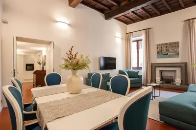 a dining room with a table and blue chairs at Avila Palace Piazza Navona in Rome