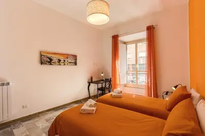 a bedroom with two beds and a window at Domus Vita Romana in Rome