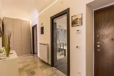a hallway with a door and a tile floor at Domus Vita Romana in Rome
