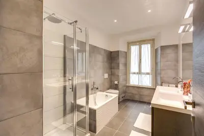 a bathroom with a shower and a tub and a sink at Domus Vita Romana in Rome
