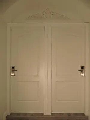 a white garage door with two lights on it at Anfiteatro Suite in Rome