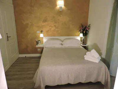 a bedroom with a bed with two towels on it at Anfiteatro Suite in Rome